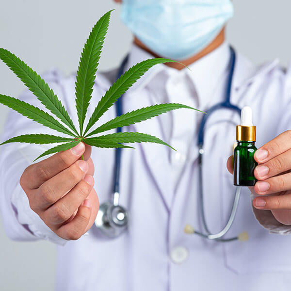 Medical Doctor holding cannabis leaf bottle cannabis oil